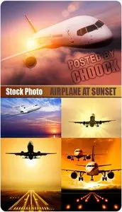 Airplane at sunset - Stock Photo