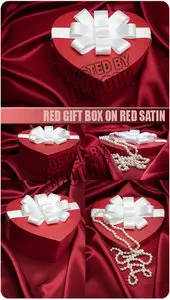 Stock Photo: Red gift box on red satin
