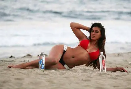 Shawna Craig posing with 138 Water bottles on the beach during 4th of July party in Malibu