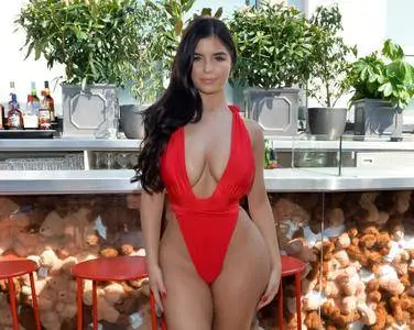 Demi Rose signing the contract with online fashion retailer ISAWITFIRST