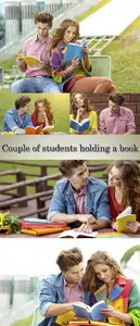 Couple of students holding a book outdoors and smiling