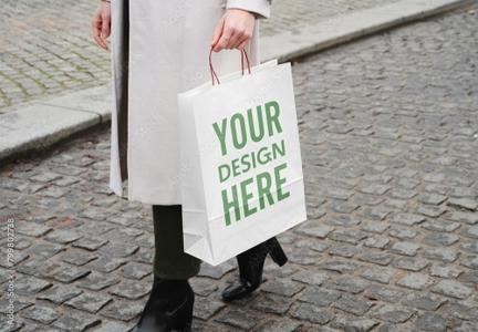 Mockup of woman with customizable paper shopping bag 799802738
