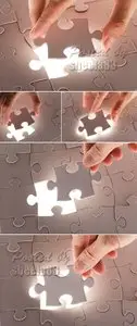 Stock Photo - Hand Holding Puzzle Piece